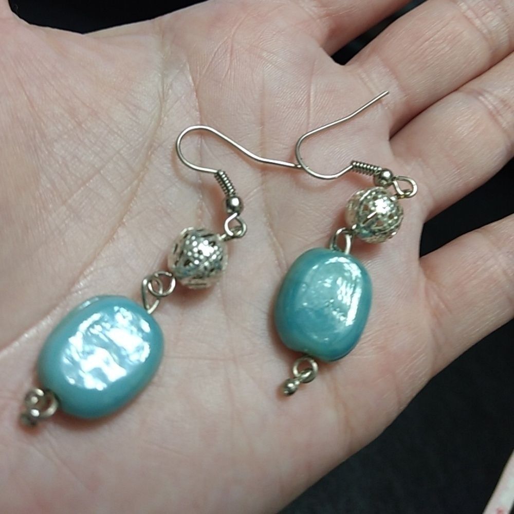 Silver tone dangling earrings blue filigree